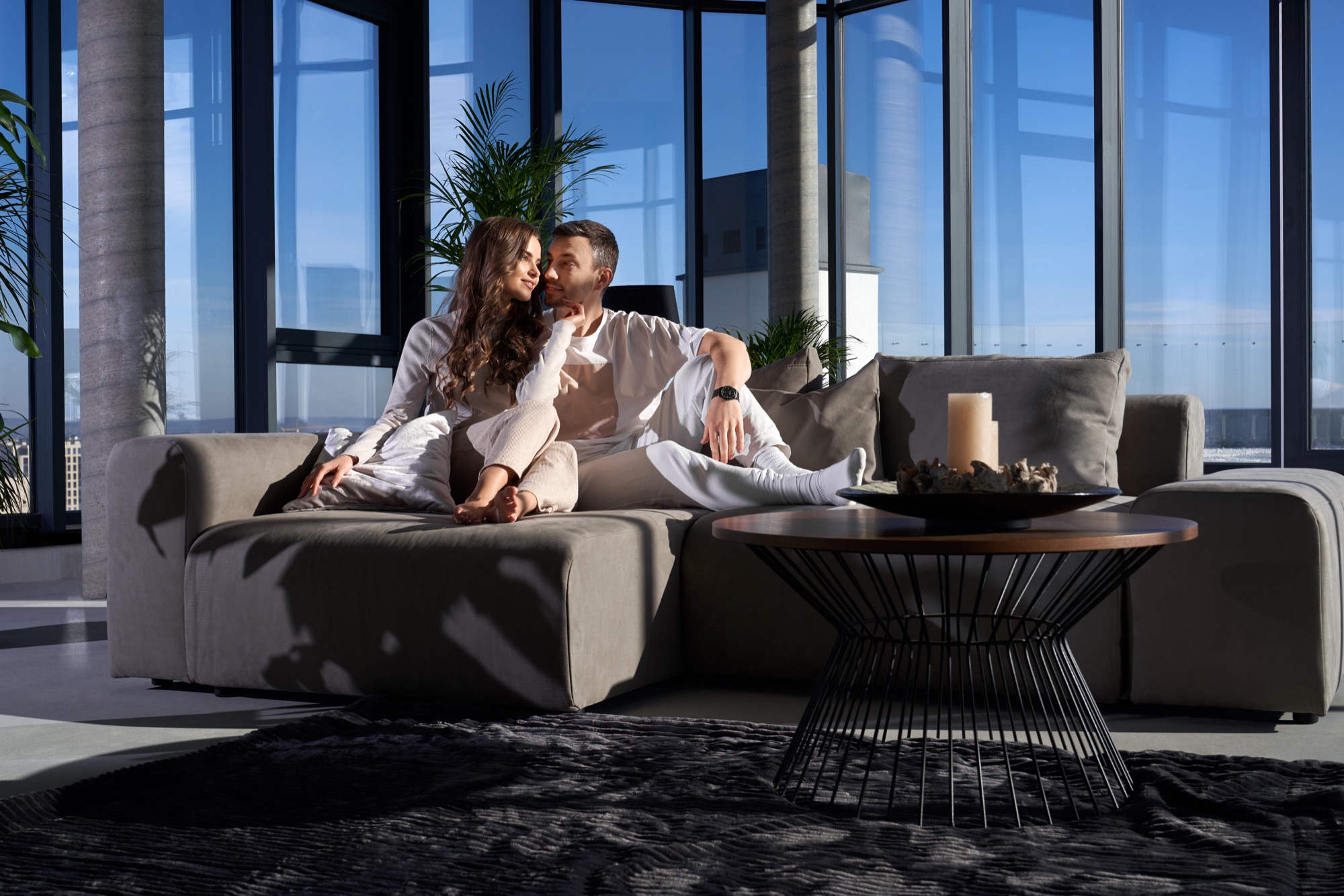 Sugar daddy and sugar baby relaxing together in a modern Montreal apartment
